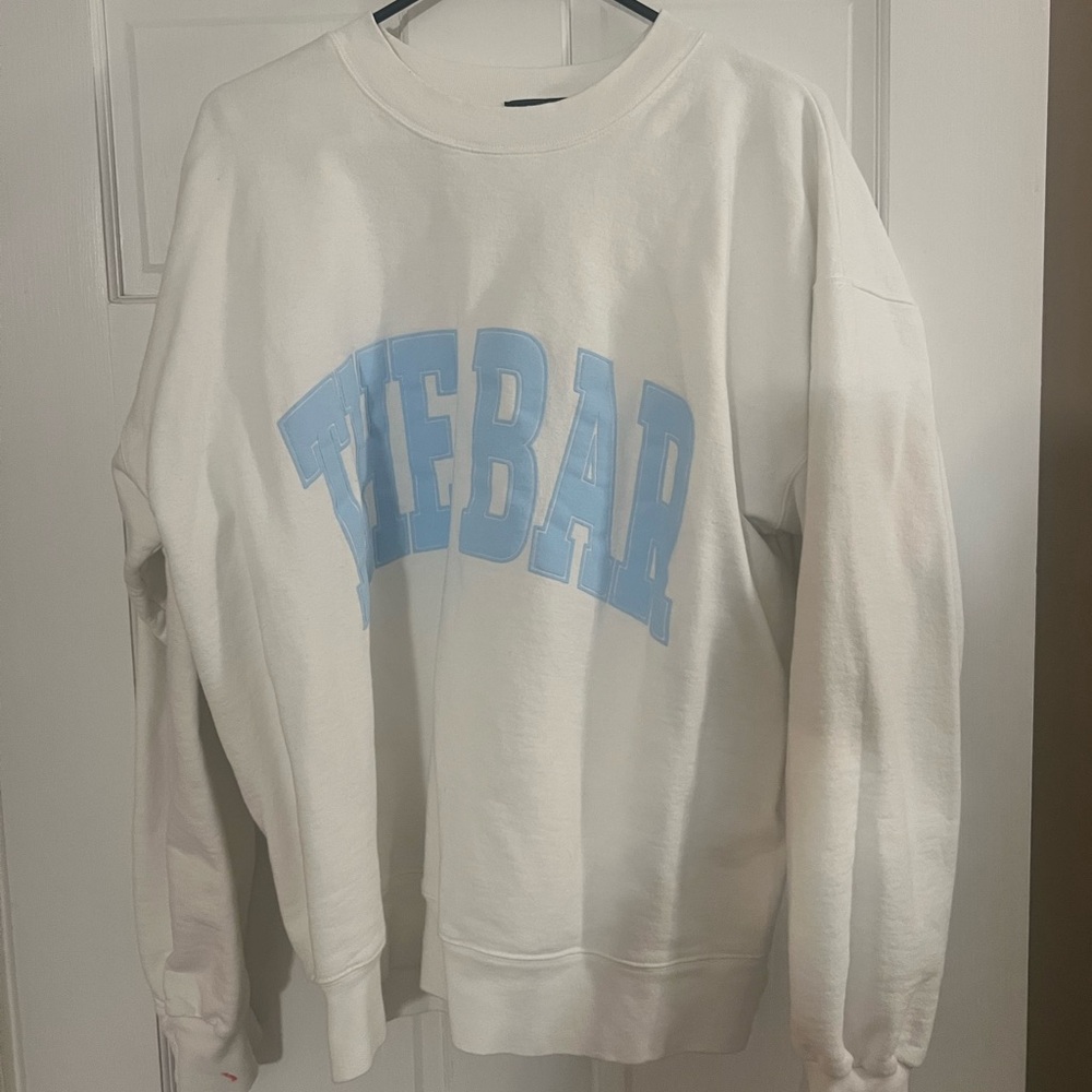 The bar white sweatshirt with light blue writing.